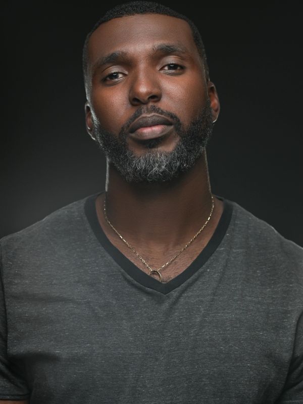 Portrait of a man with a gray beard and gray shirt.
