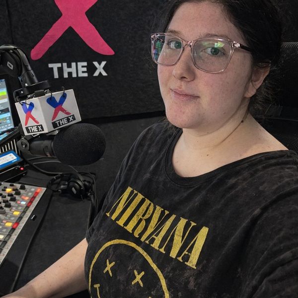 Radio host in studio wearing a Nirvana t-shirt.
