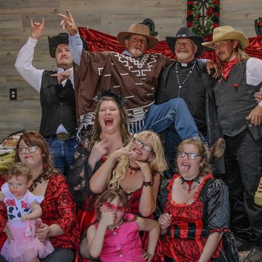 A family of men, women, and children celebrating at a wedding.