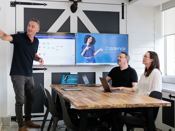 Cadence communications consultants in a meeting room designing a customer journey messaging flow