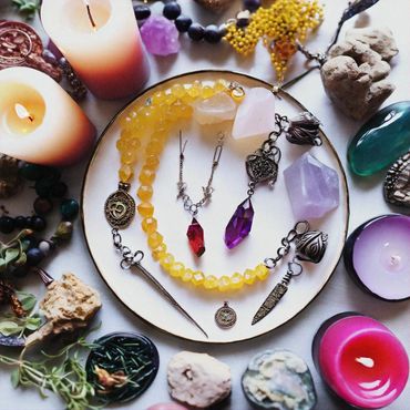 Bright colored crystals and candles on marble.