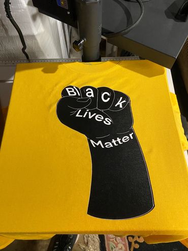 Black Lives Matter Fist by ProfessorRaptor25 on a Yellow T.