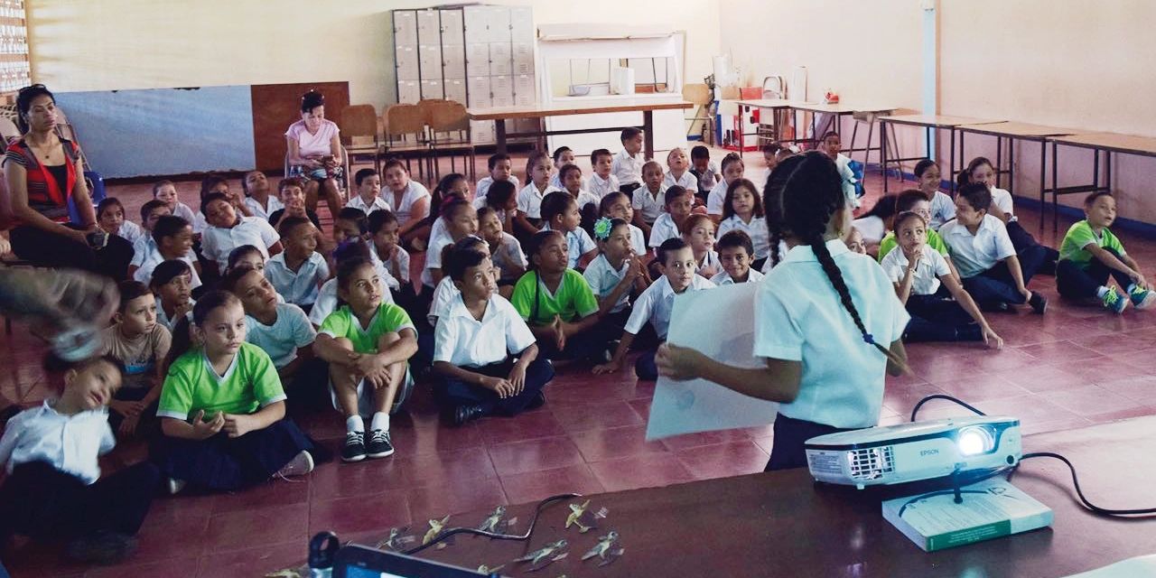 A kid presenting in front of her class