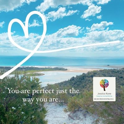 Scenic coastal view with uplifting quote and heart graphic.