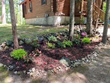 Fresh mulch, plants and flowers before the deer take them. VRBO Happy Daze Cabin with Lake State