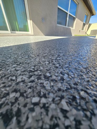 Polyaspartic patio coating, Wombat flake color.
