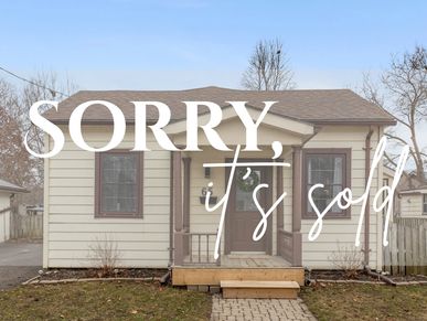 Small house with a sign reading 'SORRY, it's sold'.