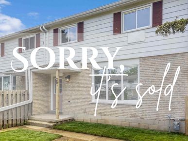 Townhouse with 'Sorry, it's sold' text overlay in front yard.