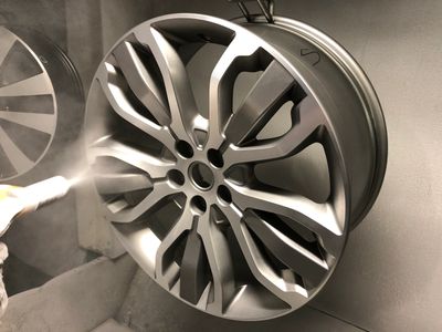 Electrostatic dry powder coat lacquer application to 21"           Range Rover wheel