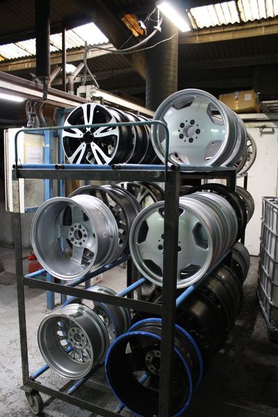 Refurbished alloy wheels in workshop at spit and polish