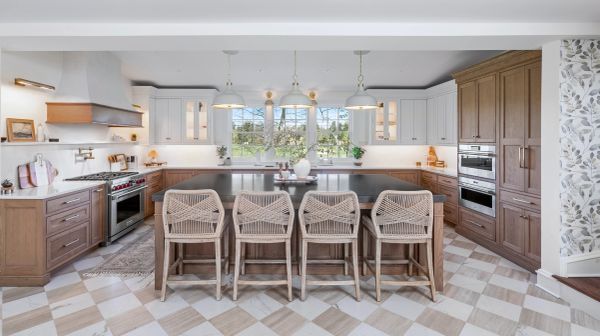Spacious modern kitchen with wooden cabinets and island seating.
