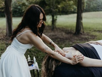 Woman giving a massage outdoors.