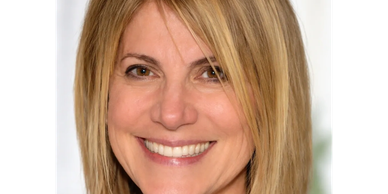 Woman with blonde hair smiling at the camera.