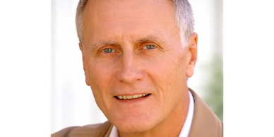 Smiling older man with gray hair.