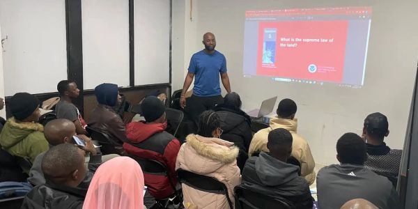 Man teaching a group about law in a classroom.