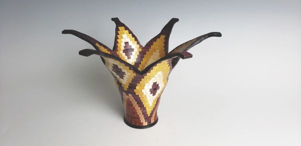 All natural colors.  1344 pieces of wood. Looks like a flower bowl.