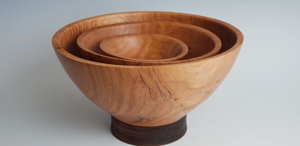 A Trio of Footed Bowls nested one inside another.  Cherry on top of walnut feet.