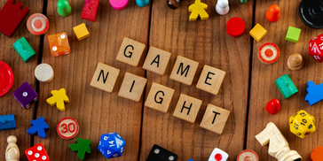 variety of game pieces with game night spelled in the middle