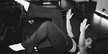 Woman exercising on the floor in a gym.