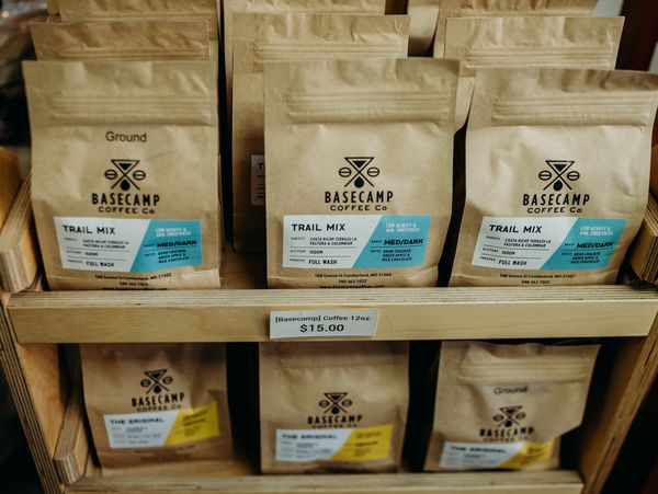 Shelves containing bags of Basecamp Coffee