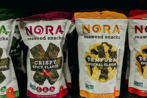 Shelf containing bags of Nora brand seaweed snacks