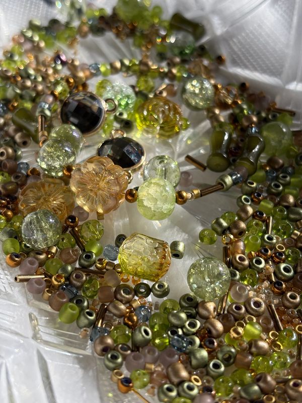 Close-up of assorted colorful beads and jewelry pieces.
