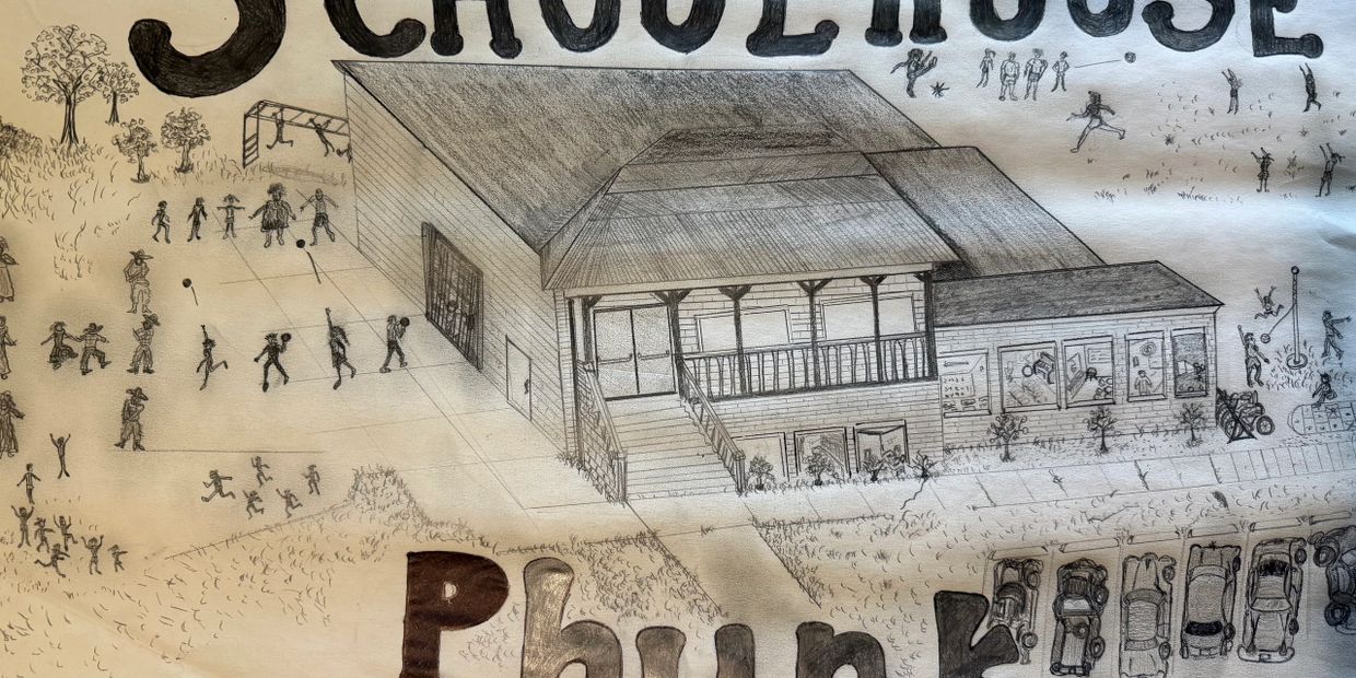 Group of school children engaged in various school yard activities and a school in the foreground.