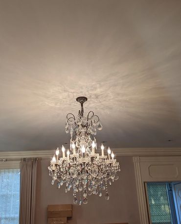 Crystal light fixture installation in dining room
