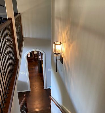 Wall sconce lighting over stairway