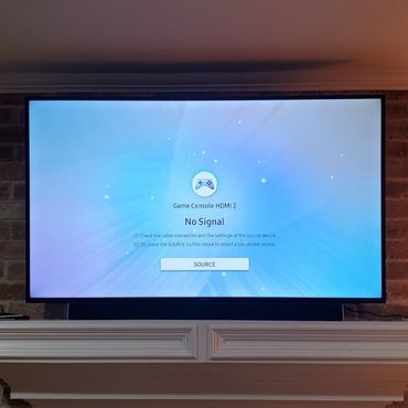 flat screen tv mount on the wall over brick fireplace