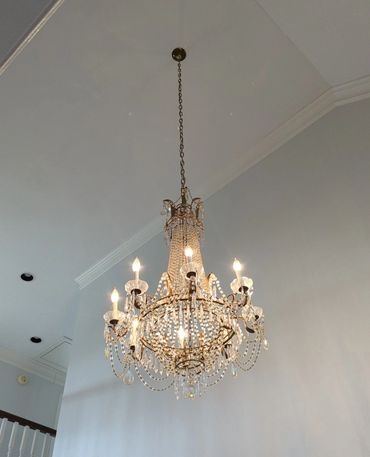 high ceiling crystal light fixture in living room