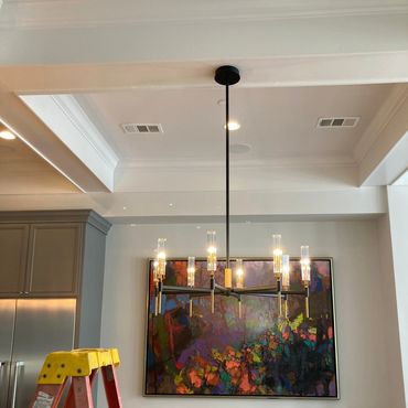 Modern light fixture in dining room of customers home