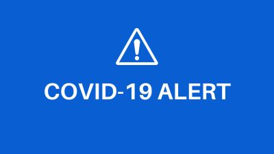Blue screen displaying a COVID-19 alert with warning symbol.