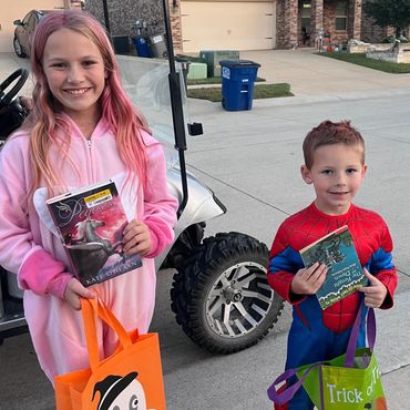 Kids proudly holding the books they picked, reminding us why literacy, kindness, and community matte