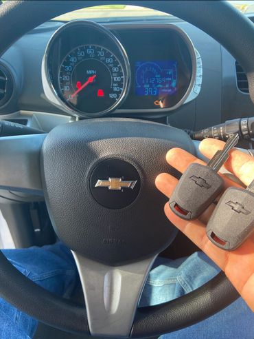 Chevrolet car interior with keys and dashboard visible.