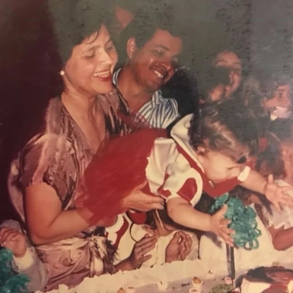 A joyful family celebrating a child's birthday with cake and smiles.