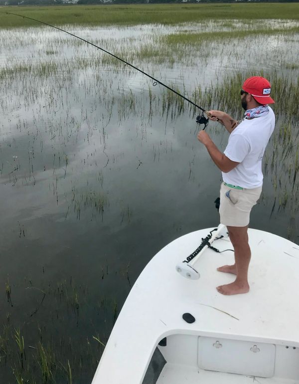 Reeling in a fish on the flooded marsh