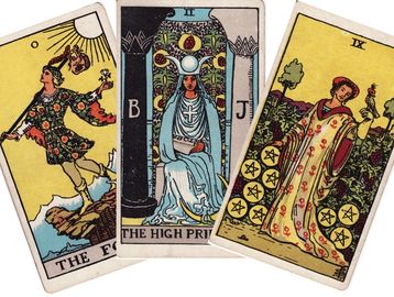 Three tarot cards: The Fool, The High Priestess, Nine of Pentacles.