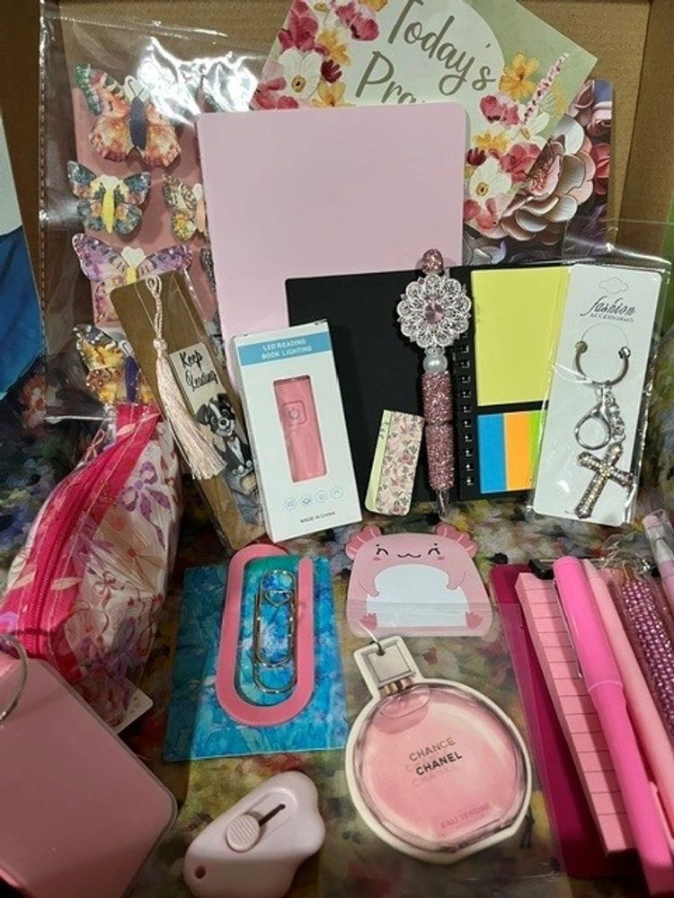 A collection of colorful stationery and accessories with a pink theme.