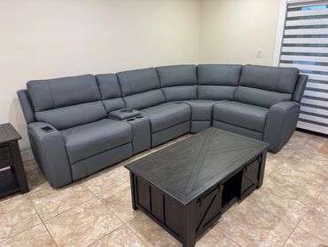 Modern gray sectional sofa in a neutral living room.