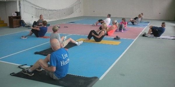Members of an exercise class -- these participating in floor exercises -- at Vientos Bajos in Costa
