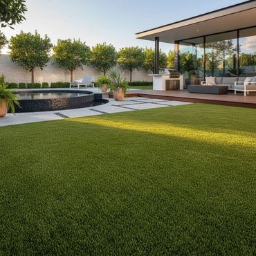 Modern backyard with lush lawn, pool, and outdoor seating area.