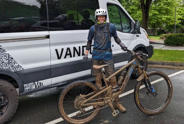 Head Coach Scott Weeks and bike covered in mud after the 2024 Fire Mountain Inferno enduro race.
