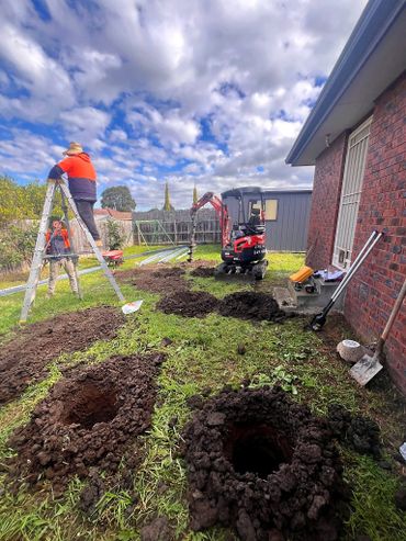 Auger holes for a patio.