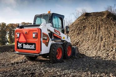 Bobcat skid-steer loader starting motocross track works.