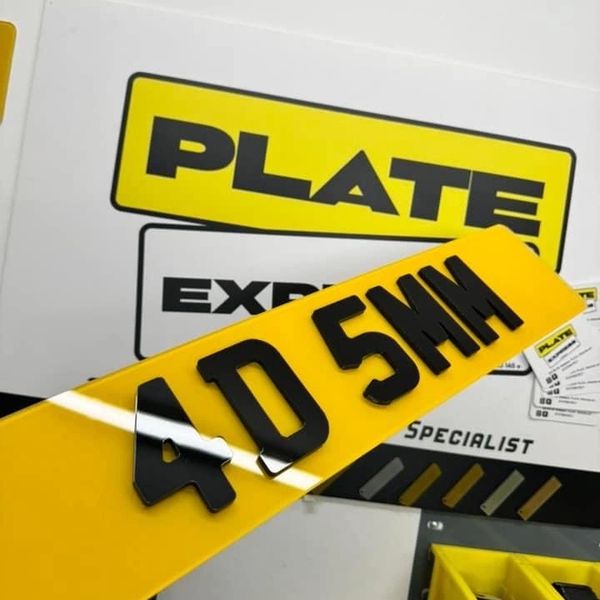 Yellow license plate with raised black characters '4D 5MM'.