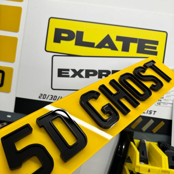 A vibrant yellow UK license plate with bold black letters and numbers.