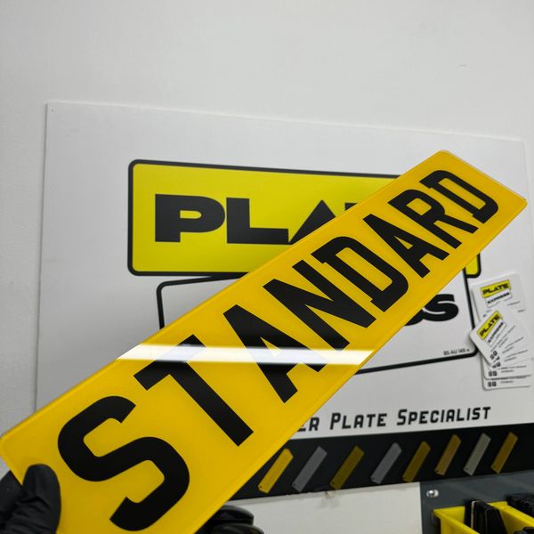 Yellow license plate with the word STANDARD in black letters.