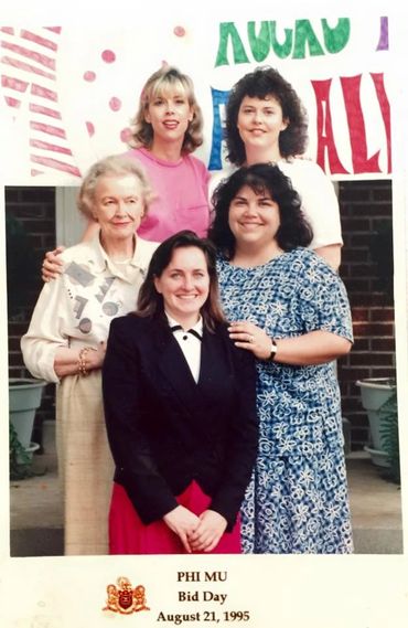 Five women posing for a Phi Mu Bid Day photo from 1995.