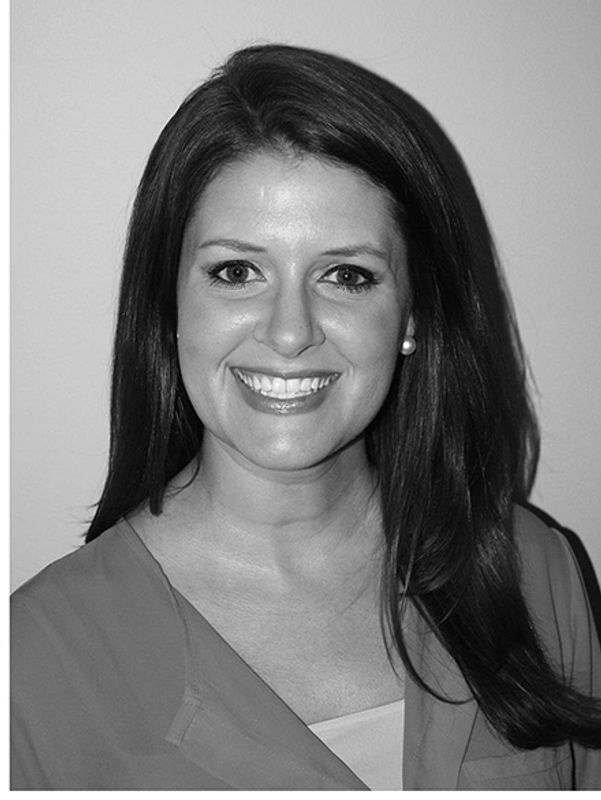 Smiling woman with long dark hair.